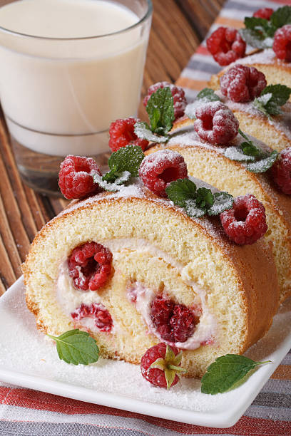 tasty cake with fresh raspberries and mint closeup and milk on the table. vertical