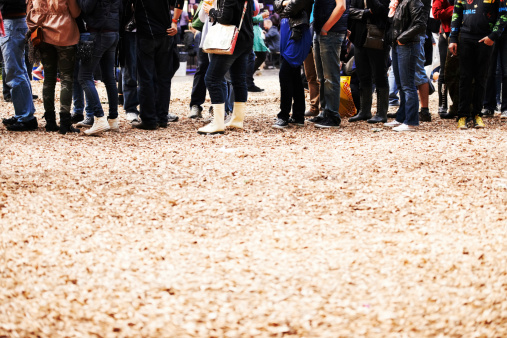 Cropped shot of the legs of a large crowd of festival goers