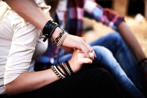 Cropped shot of a couple holding hands at a music festival