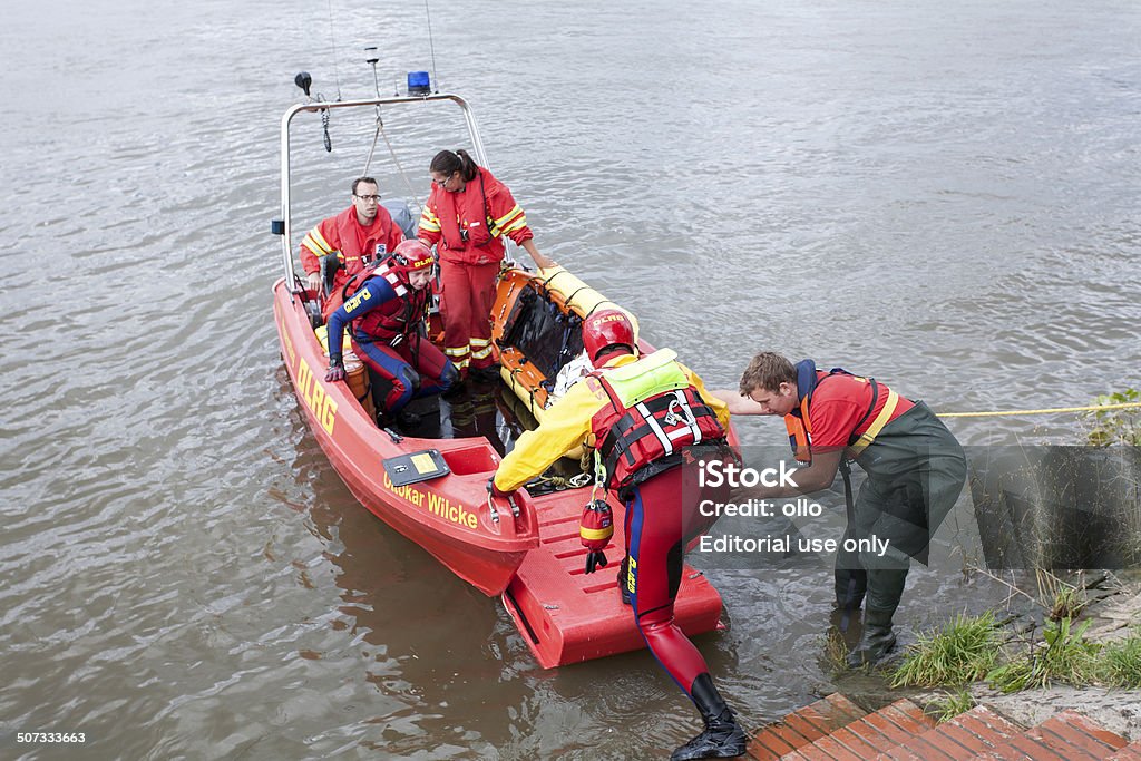 Swiftwater rescue drill / Stroemungsretter DLRG Wiesbaden, Germany - August 16, 2014: Lifeboat crew, swiftwater rescue team and lifeguards of German Deutsche Lebens-Rettungs-Gesellschaft DLRG prepare for evacuation operation during a disaster management exercise on River Rhine nearby Theodor-Heuss-Bruecke between Wiesbaden and Mainz. DLRG (Deutsche Lebensrettungsgesellschaft) is an independent NPO (nonprofit organization) based on volunteers. Assistance Stock Photo