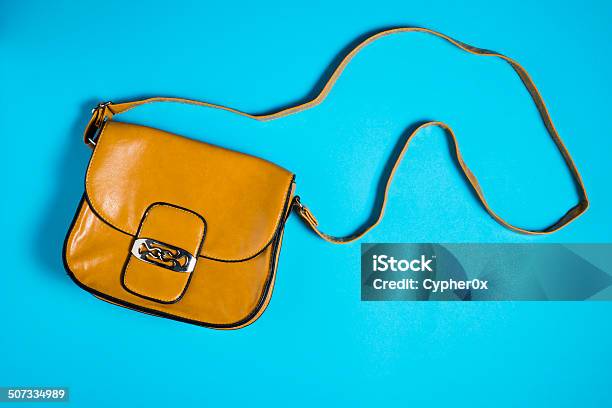 Woman Leather Purse On Blue Background Stock Photo - Download Image Now - Blue, Brown, Buckle
