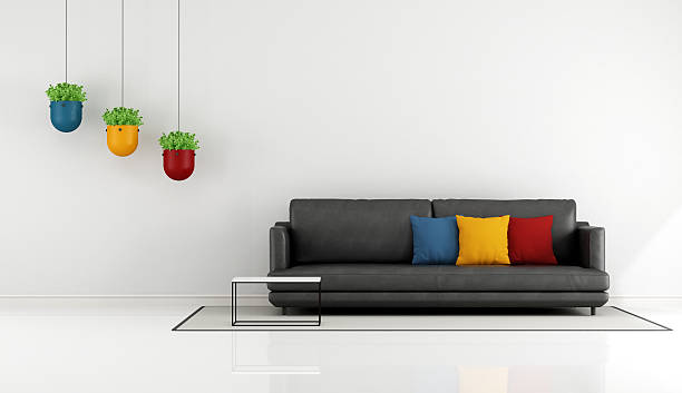 Minimalist living room Minimalist living room with black sofa and colorful cushion - 3D Rendering leather cushion stock pictures, royalty-free photos & images