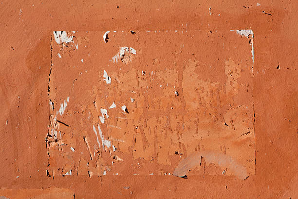 istock Traces of old announcements on terracotta wall. Background textu 507365512