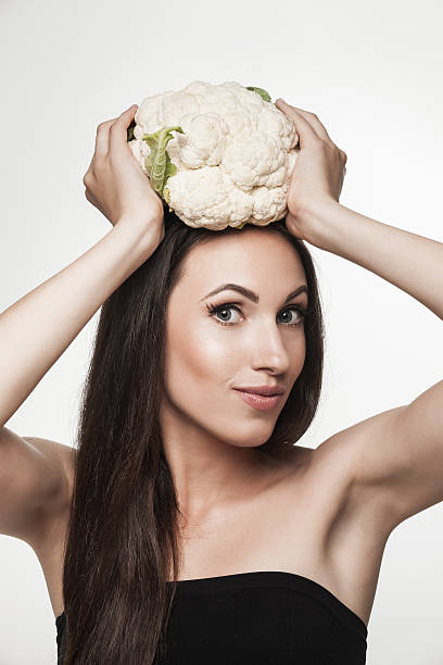 istock Funny image of woman holding cauliflower 507369412