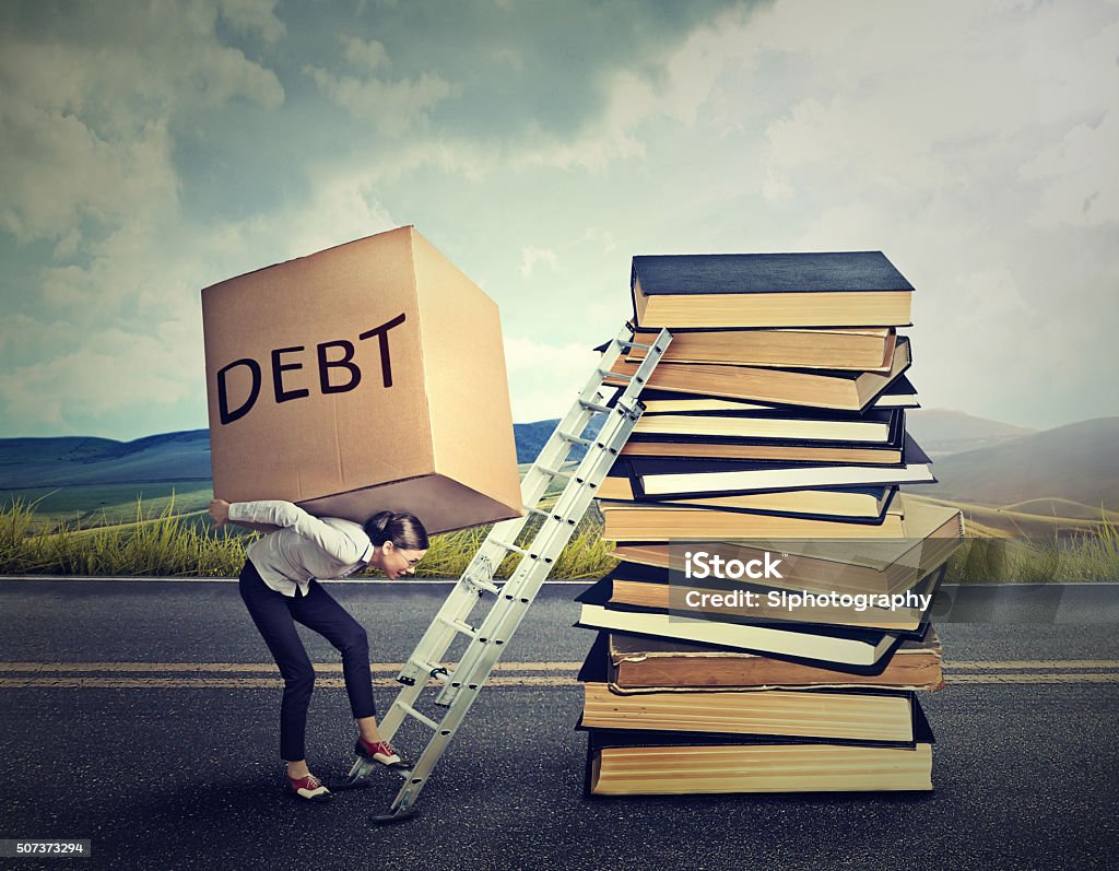 Student loan debt concept. Woman with heavy box Student loan debt concept. Young woman with heavy box full of debt carrying it up the education ladder Debt Stock Photo