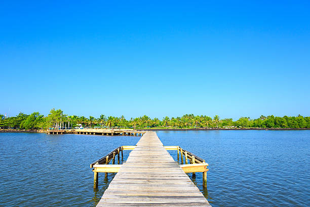 istock wooden bridge juts out into  of the sea 507373466
