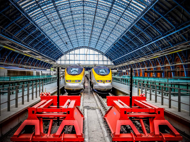 St Pancras red buffer stops with Eurostar trains London, United Kingdom - August 30, 2015: Two huge bright red steel buffer stops protect the Eurostar terminus at St Pancras Station in London as three trains wait in platforms for their turn to take passengers on the high speed journey to Paris via the Chunnel. Opened in 1868, this masterpiece of Gothic architecture underwent a magnificent restoration completed in late 2007. Eurostar stock pictures, royalty-free photos & images