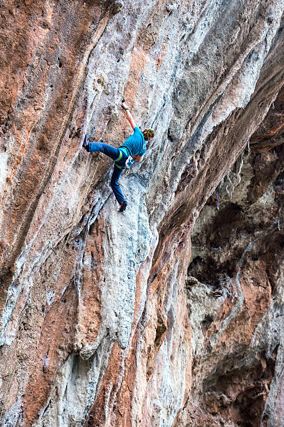 istock Young Rock Climber ascending steep colourful rocky Wall Lead Climbing 507374372
