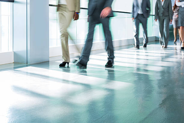 istock Group of business people walking on corridor in office building 507374545