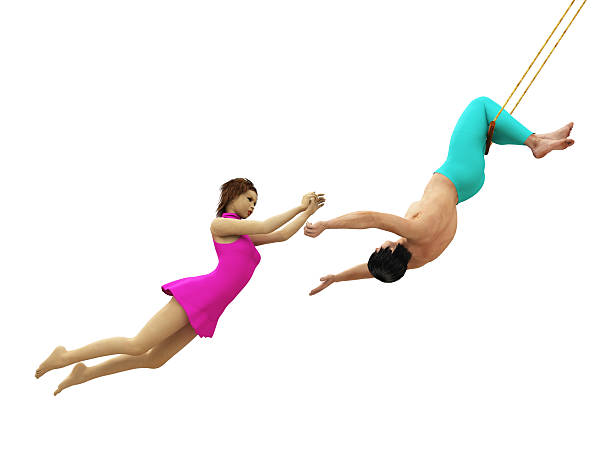 Male catcher prepares to catch female flying trapeze artist, isolated on white