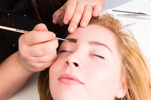 istock Esthetician Grooming Eyebrows of Female Client 507375680
