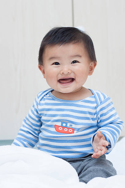 istock Cute Chinese baby boy sitting on a white blanket 507377814