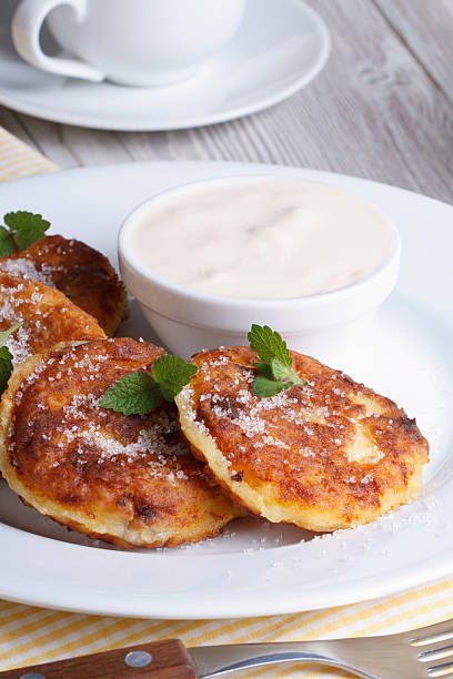istock cheese pancakes on a white plate with sour cream vertical 507395163
