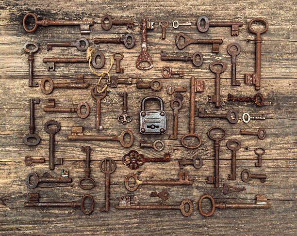 many keys on wood with padlock many rusty keys on old wood with padlock in the middle. key strictly arranged. old key stock pictures, royalty-free photos & images