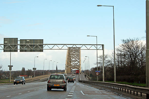 Netherlands: Waalbrug at Nijmegen Nijmegen, Netherlands - March 24, 2009: Driving up to the Waalbrug in Nijmegen, an arch bridge that was an Allied target in Operation Market Garden and made famous by A Bridge Too Far. operation market garden stock pictures, royalty-free photos & images