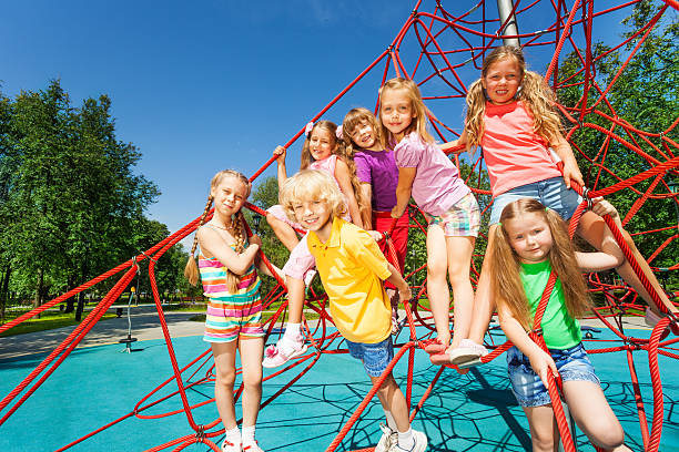 istock Group of kids sitting together on red ropes 507396417