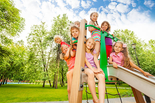 istock Happy kids on playground chute in the park 507396421