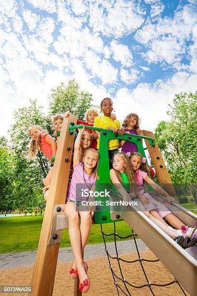 Group Of Friends Together On A Chute In Summer Stock Photo - Download Image Now - Child, Playground, Playing