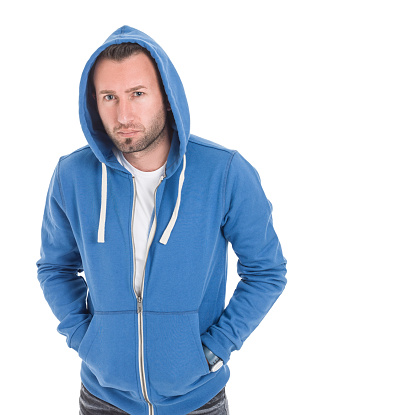 Young casual man in hoodie standing on white with hands in pockets. Image taken with medium format Hasselblad H3D camera system and developed from camera RAW.