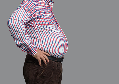 Overweight man standing, close up. Studio shot. Image taken with Hasselblad H3D camera system and developed from camera RAW.