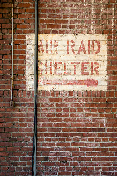 Air Raid Shelter Sign Painted on a Brick Warehouse stock photo