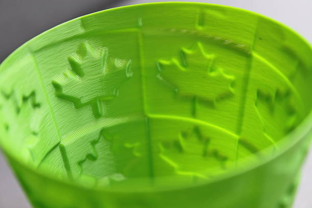 3D printed cup with maple leaf motiv Bright green 3D printed cup with maple leaf motiv polylactic acid stock pictures, royalty-free photos & images