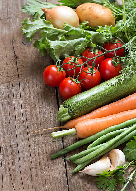 istock Organic vegetables and greens on a wooden table 507399479