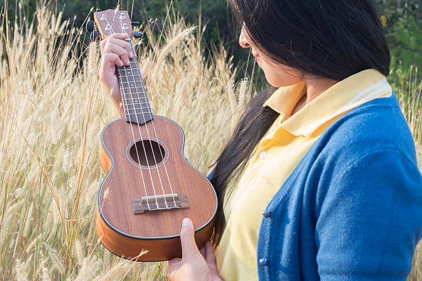 istock Beautiful asian women with ukulele 507399640