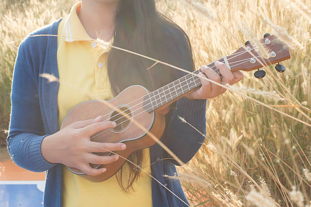 istock Beautiful asian women with ukulele 507399990
