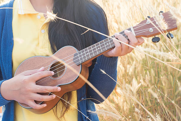 istock Beautiful asian women with ukulele 507400068