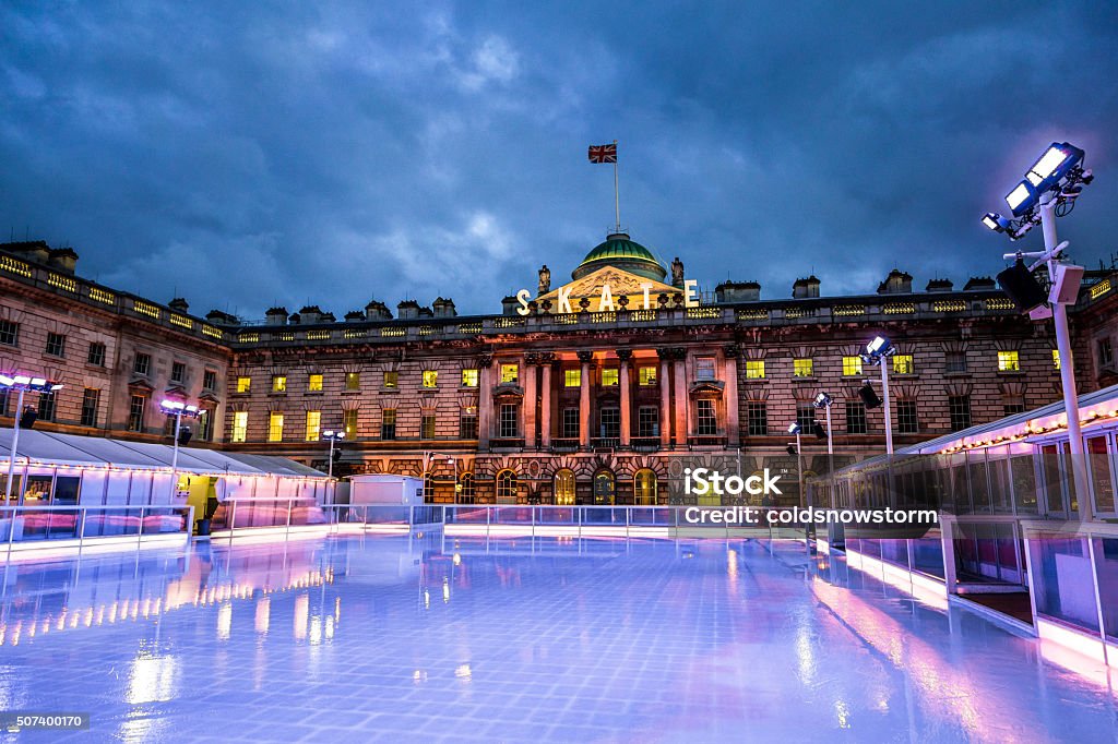 Empty ice skating rink, Somerset House, The Strand, London, UK The Christmas ice skating rink at Somerset House on The Strand in central London, UK. The ice rink is empty with no people on it, as it is just about to be cleaned and maintained by the special ice machines. The sun is about to set and the sky features a moody and ominous cloudscape. Horizontal colour image with room for copy space. Ice Rink Stock Photo