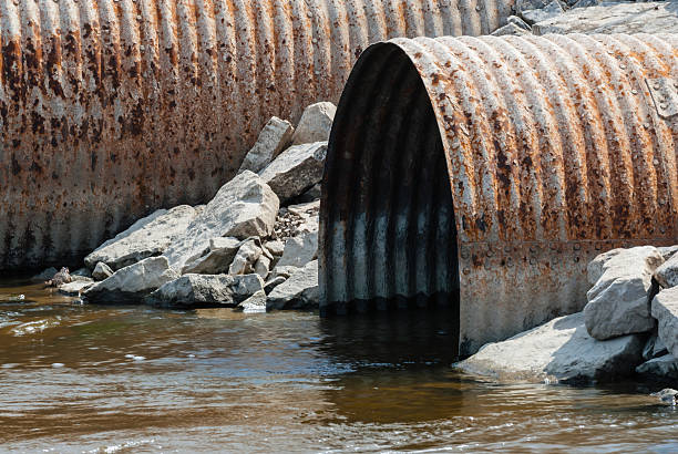 istock Rusted culvert pipe opening in water 507400203