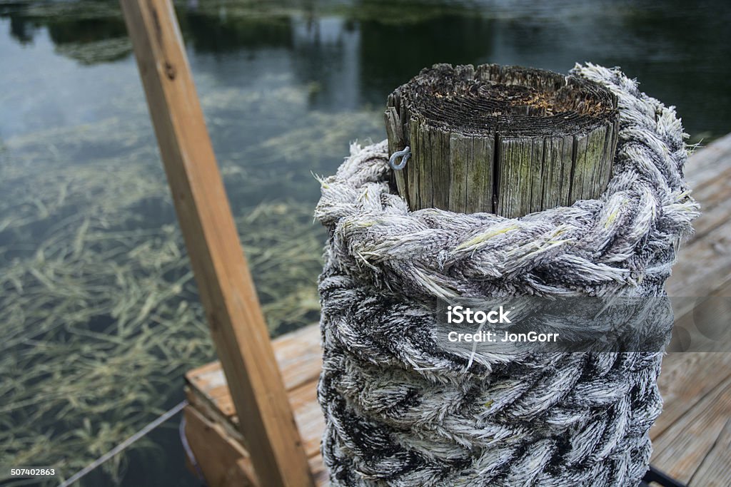 Nautical Rope Around Wood Telephone Pole On Wooden Dock Macro Eel Grass Stock Photo