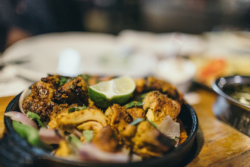 Close-up of a chicken Tikka dish, in a cast iron frying pan.Close-up of a chicken Tikka dish, in a cast iron frying pan.