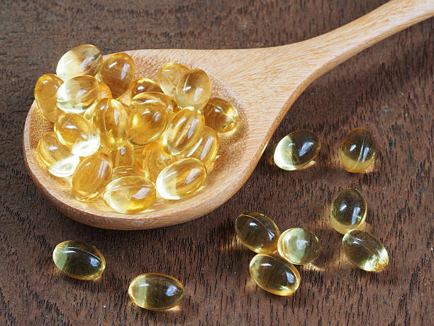 istock Fish oil capsules in a spoon 507419724
