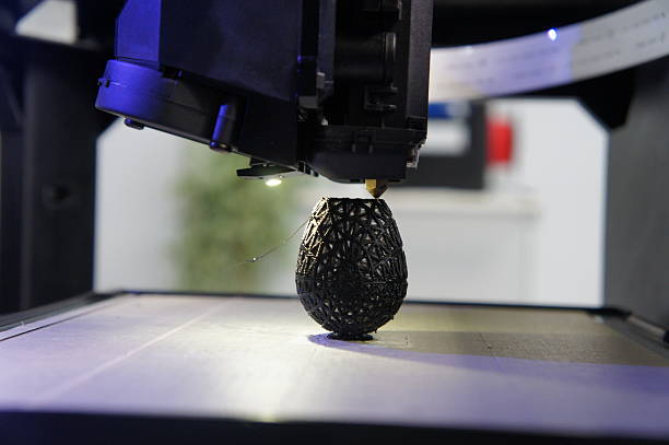 3D printed black egg Black egg being 3D printed on printbed with extruder and fan in action polylactic acid stock pictures, royalty-free photos & images