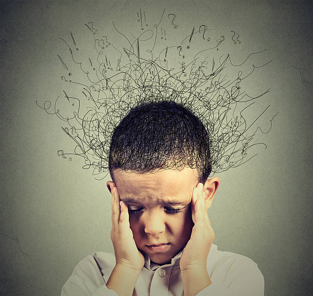 sad boy with worried stressed face expression looking down Closeup sad boy with worried stressed face expression looking down with brain melting into lines question marks. Obsessive compulsive, adhd, anxiety disorders concept mindfulness children stock pictures, royalty-free photos & images