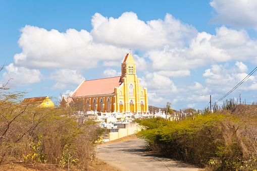 The Church of St. Willibrordus with rectory and cemetery in Sint Willibrordus on the island of Curacao. Sint Willibrordus Roman Catholic church was built between 1884 and 1888 in the Neo-Gothic architectural style common for churches built in that period.