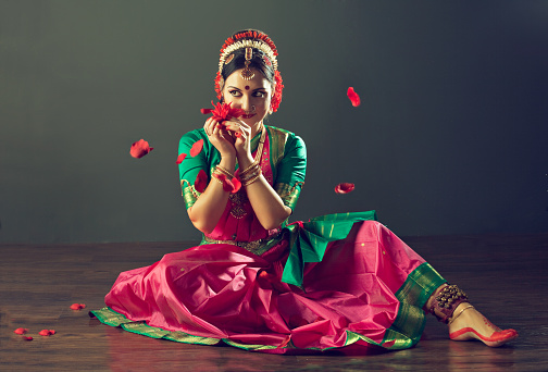 Girl, dressed in traditional national costume, dancing classical indian dance Kuchipudi. Emotional gestures of indian dance kuchipudi. 
