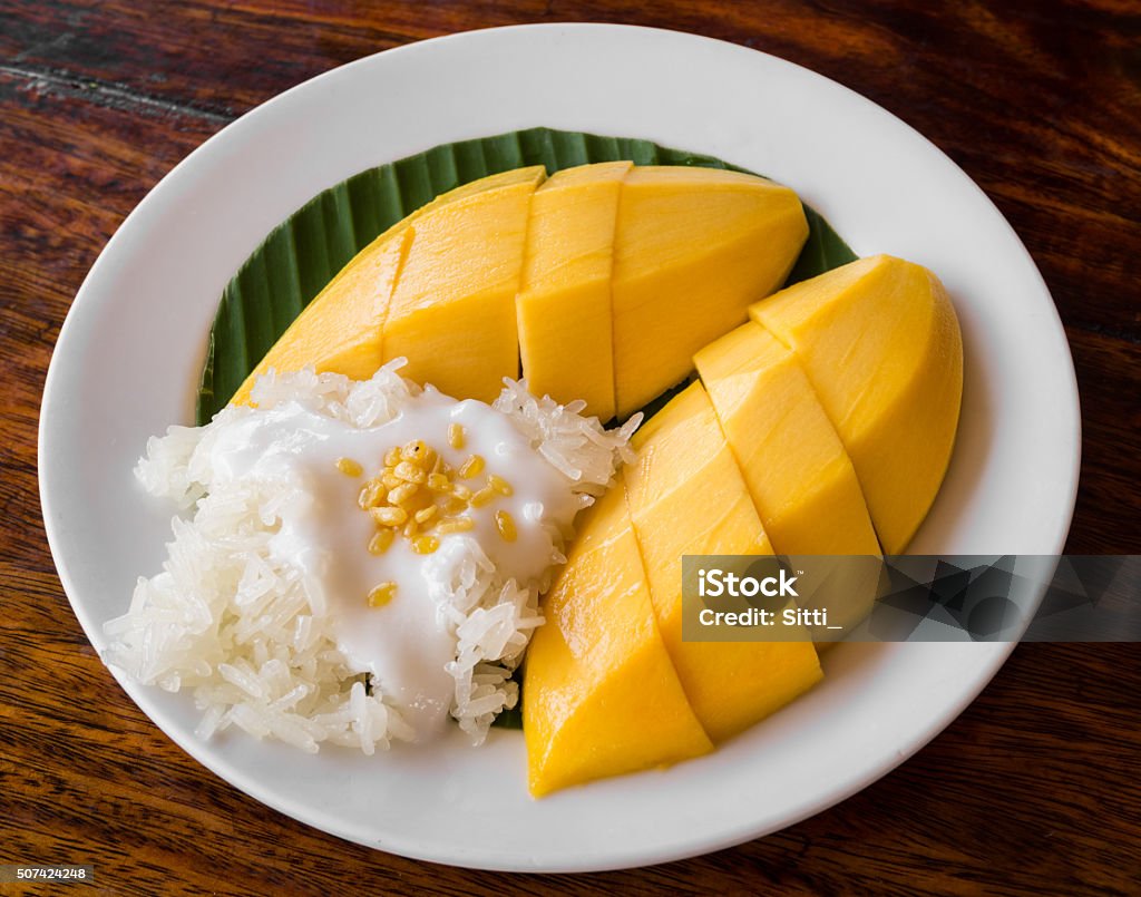 Thai style tropical dessert, glutinous rice eat with mangoes Rice - Food Staple Stock Photo