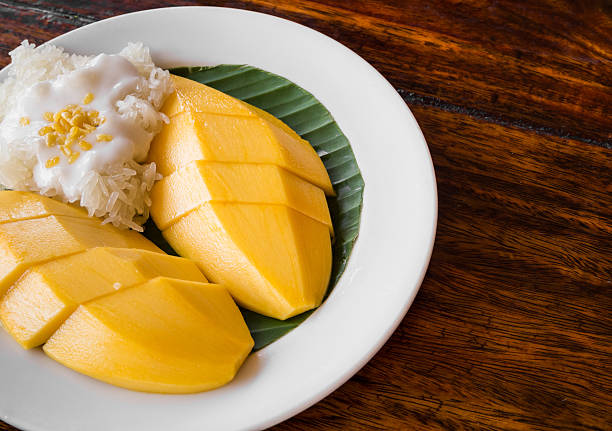 istock Thai style tropical dessert, glutinous rice eat with mangoes 507424336