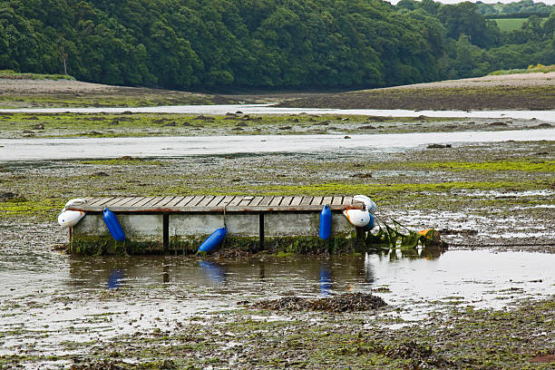 Landing stage aground at low tide in a creek UK