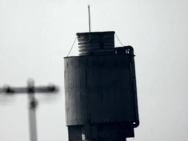 Grunge monochrome concrete watertank slightly tilted with film like noise and soft focus