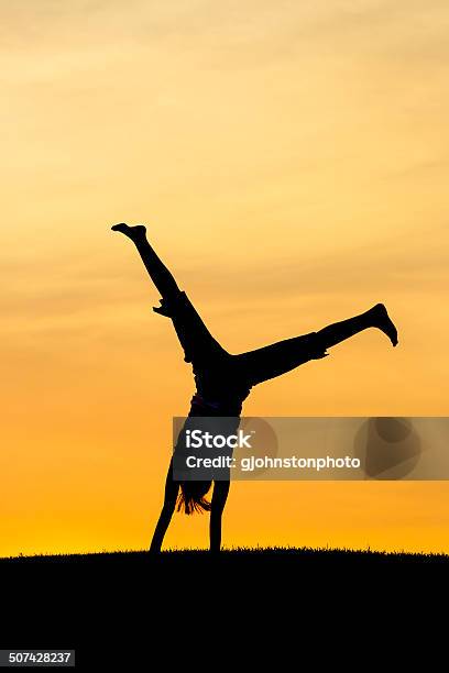 Portrait Of A Cartwheel Stock Photo - Download Image Now - Cartwheel, In Silhouette, Girls
