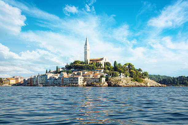 Town of Rovigno in Istria, Croatia. Taken on a bright sumer day from the sea. The church of St. Euphemia can be seen on top of the old town. Mediterranean, summertime, tourism concept.