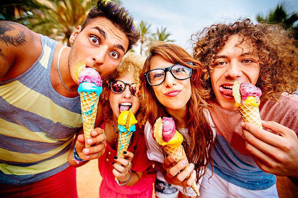 Friends Taking Selfie With Ice Cream group of friends taking selfies with their ice cream licking ice cream cone stock pictures, royalty-free photos & images