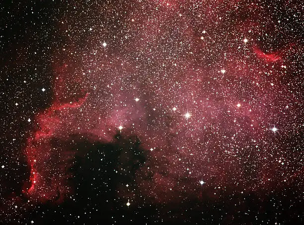 The North America Nebula (NGC 7000) is an emission nebula in the constellation Cygnus, close to Deneb (the tail of the swan and its brightest star). The remarkable shape of the nebula resembles that of the continent of North America, complete with a prominent Gulf of Mexico.