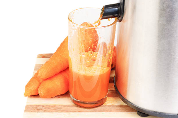 istock Juice machine and carrot juice isolated on white 507429875