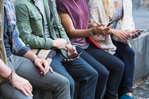 istock Young adults with mobile phones 507431069