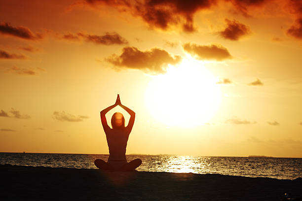 istock sunset yoga woman 507431301
